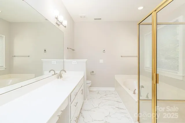 a bathroom with a double vanity sink mirror and shower