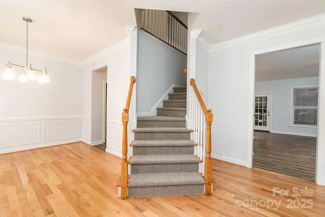 a view of entryway and hall with wooden floor