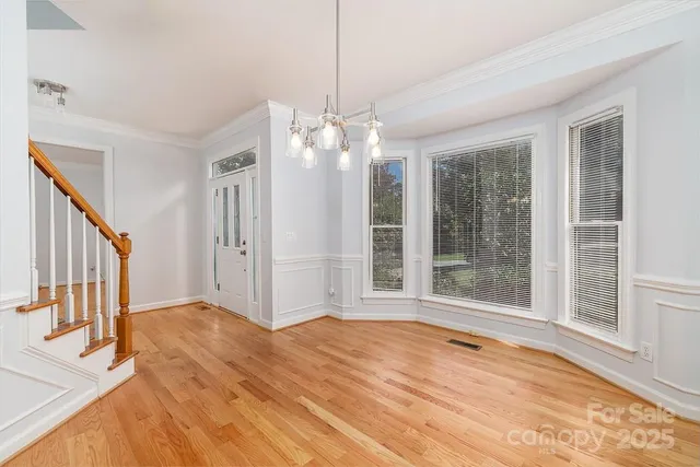 a view of a livingroom with wooden floor and entryway