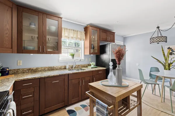 a kitchen with a stove a sink and a refrigerator