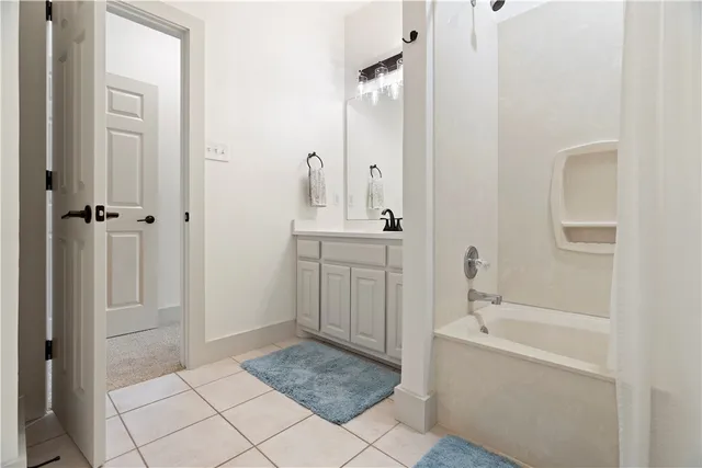 a bathroom with a sink a mirror and a bathtub