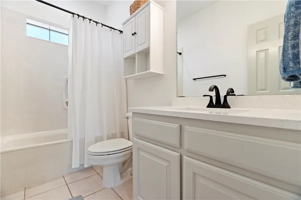 a bathroom with a sink a toilet and a shower