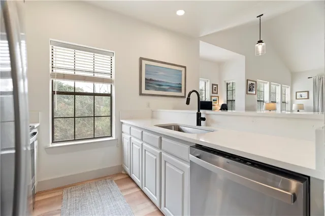 a kitchen with a sink cabinets and window