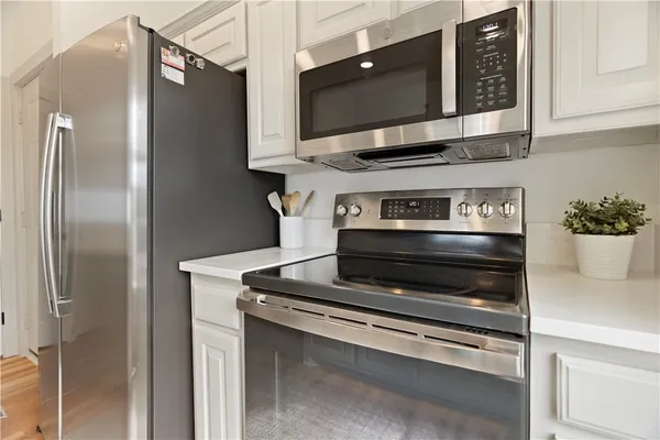 a kitchen with appliances and cabinets