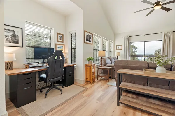 a view of a workspace with furniture and a window