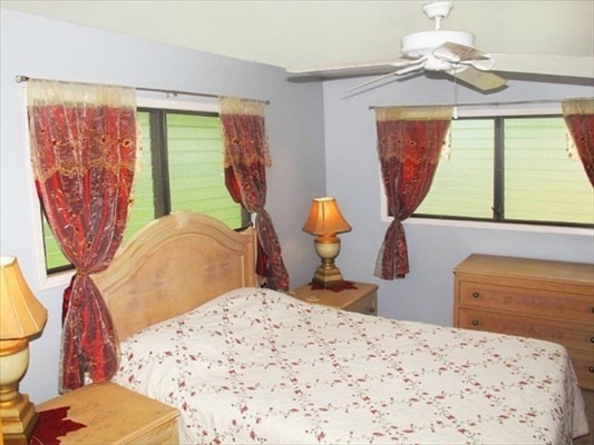 7935 Ulili Road Kekaha, HI 96752 - Photo 16 of 20 a bedroom with two beds and a chandelier