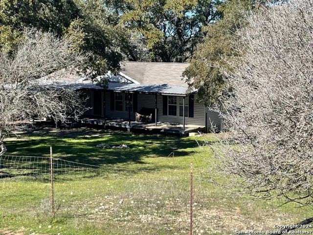 a view of a house with a yard porch and sitting area