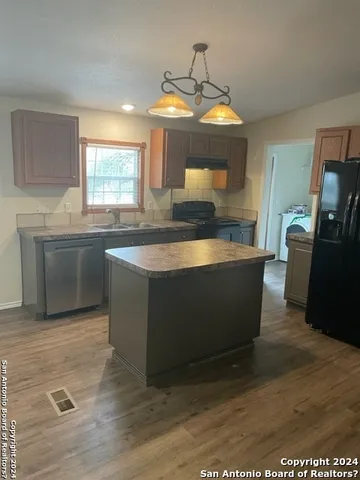 a kitchen with stainless steel appliances granite countertop a sink and a microwave