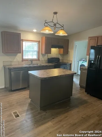 a kitchen with stainless steel appliances granite countertop a sink and a stove