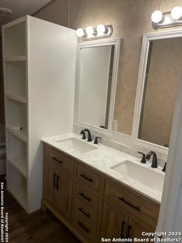 a bathroom with a sink double vanity and a mirror