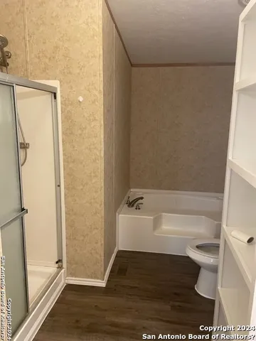 a bathroom with a bathtub and toilet