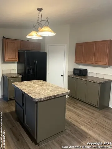 a kitchen with granite countertop a counter top space a sink stainless steel appliances and cabinets