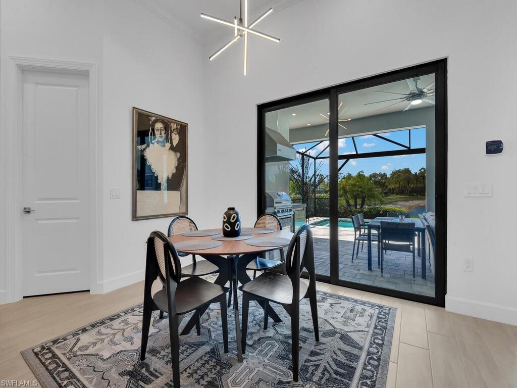 7229 Wiregrass Court Naples, FL 34114 - Photo 11 of 40 a view of a dining room with furniture window and outside view