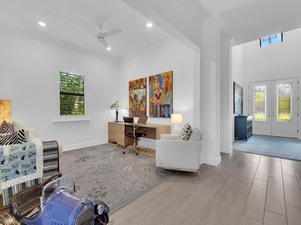 7229 Wiregrass Court Naples, FL 34114 - Photo 14 of 40 a living room with furniture and wooden floor