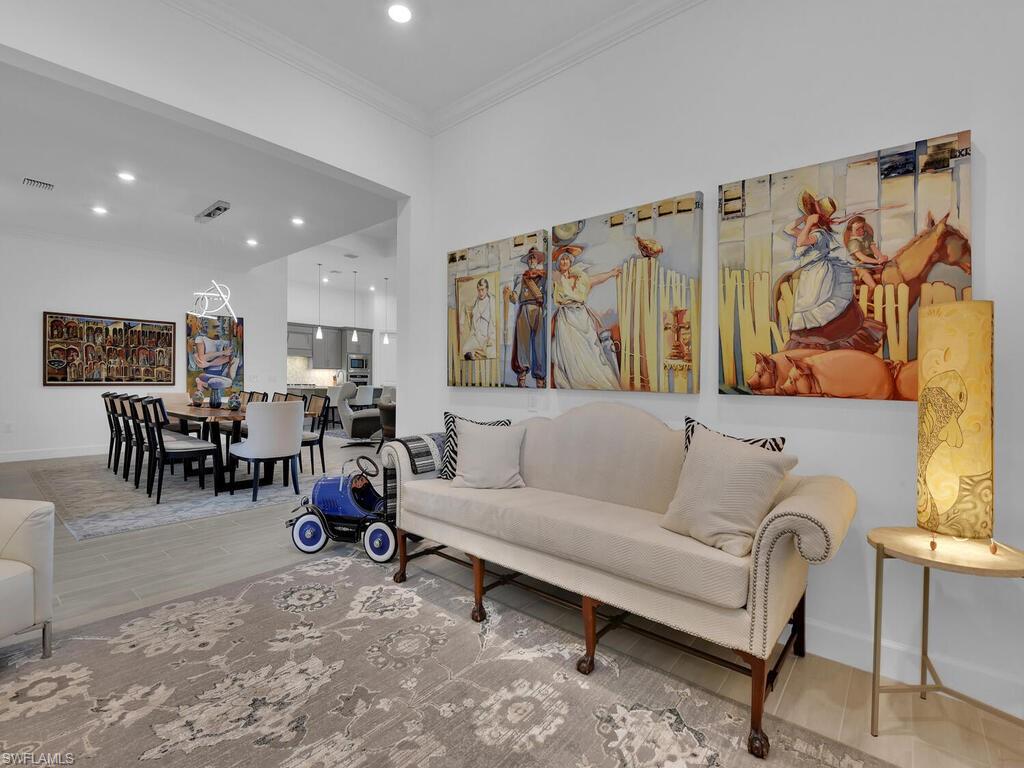 7229 Wiregrass Court Naples, FL 34114 - Photo 15 of 40 a living room with furniture and a flat screen tv