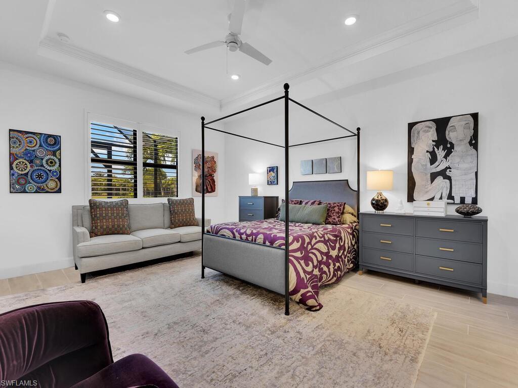 7229 Wiregrass Court Naples, FL 34114 - Photo 16 of 40 a bedroom with a bed a couch and dresser