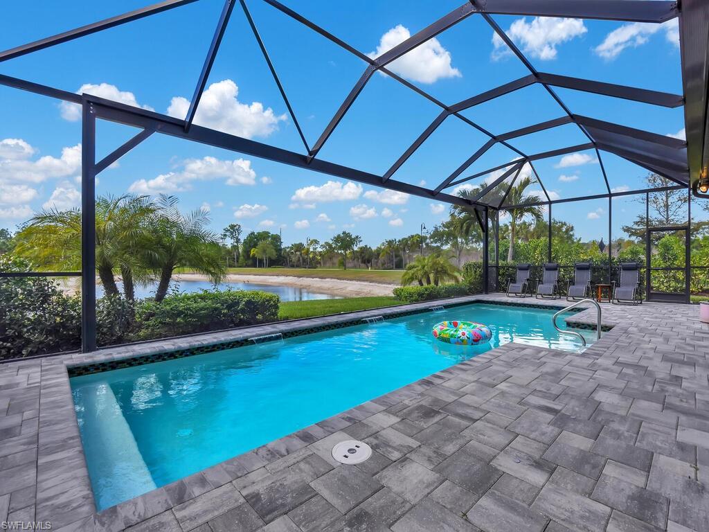 7229 Wiregrass Court Naples, FL 34114 - Photo 2 of 40 a view of a swimming pool with a patio