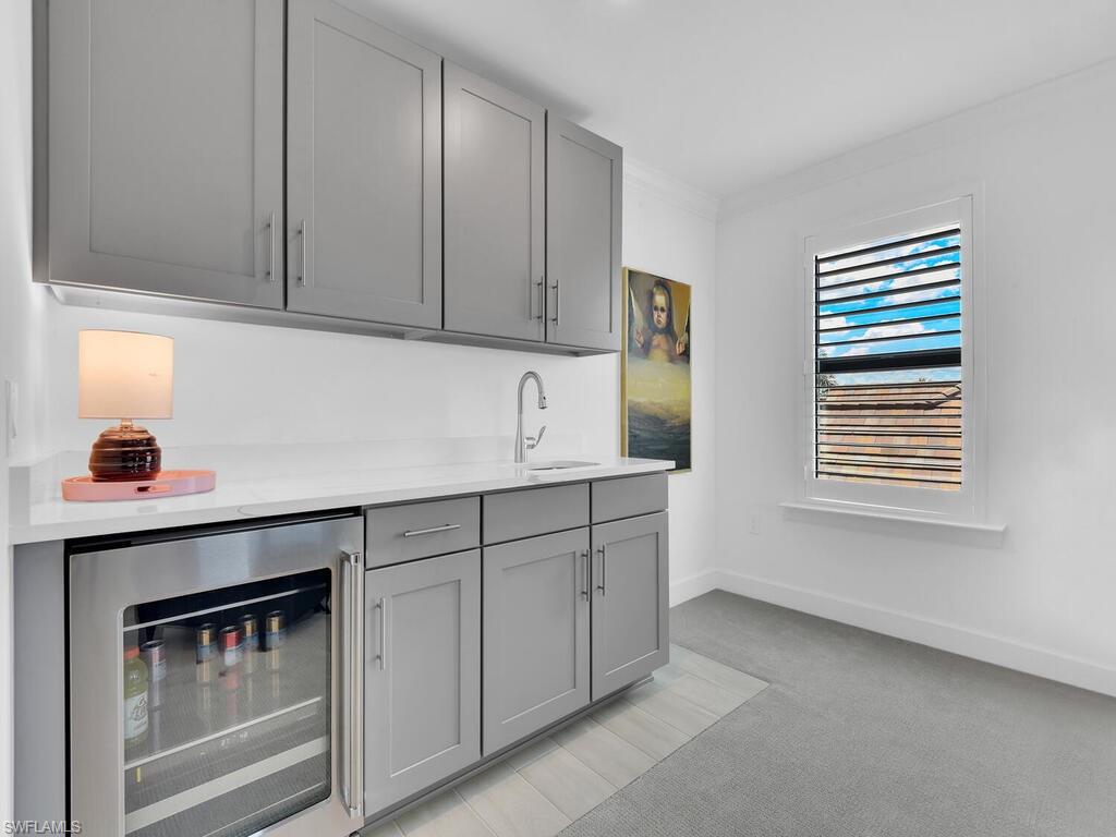 7229 Wiregrass Court Naples, FL 34114 - Photo 27 of 40 a kitchen with a sink cabinets and a window