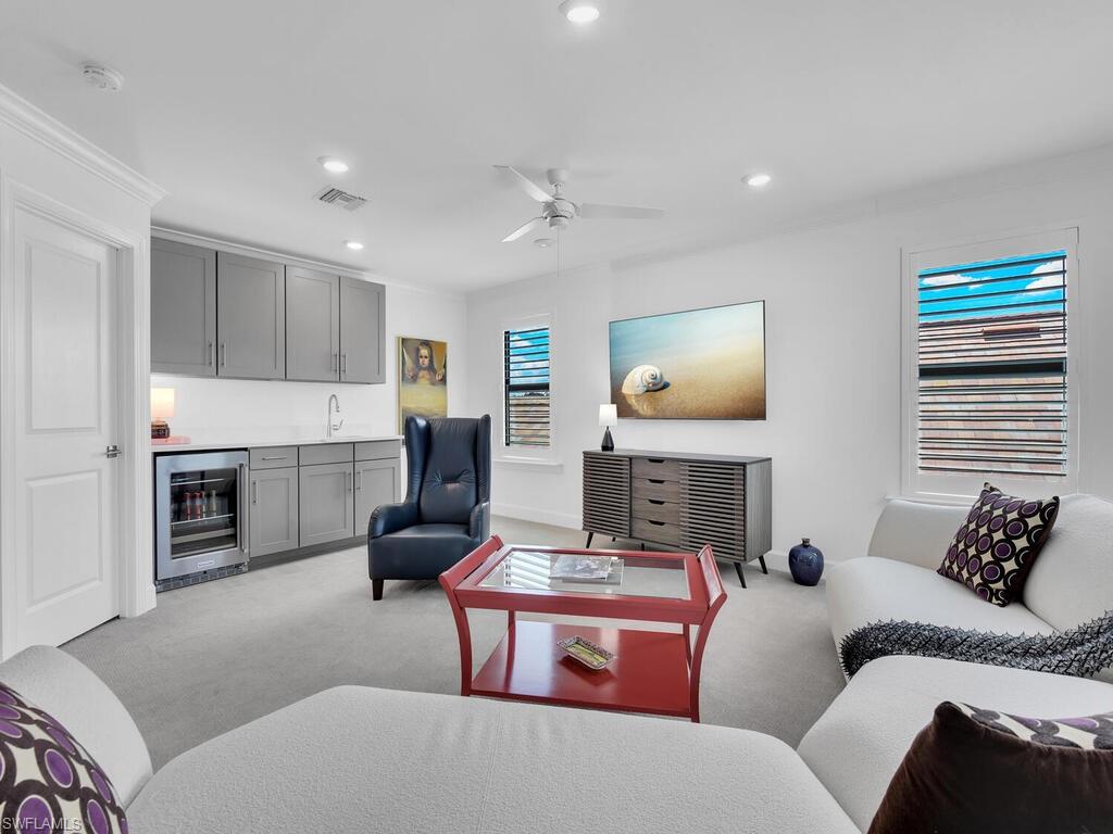 7229 Wiregrass Court Naples, FL 34114 - Photo 28 of 40 a living room with furniture and a fireplace