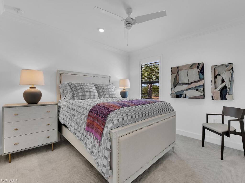 7229 Wiregrass Court Naples, FL 34114 - Photo 31 of 40 a bedroom with a bed and a dresser in it