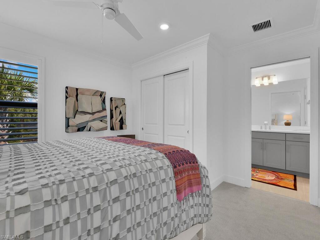 7229 Wiregrass Court Naples, FL 34114 - Photo 32 of 40 a bedroom with a bed and a window