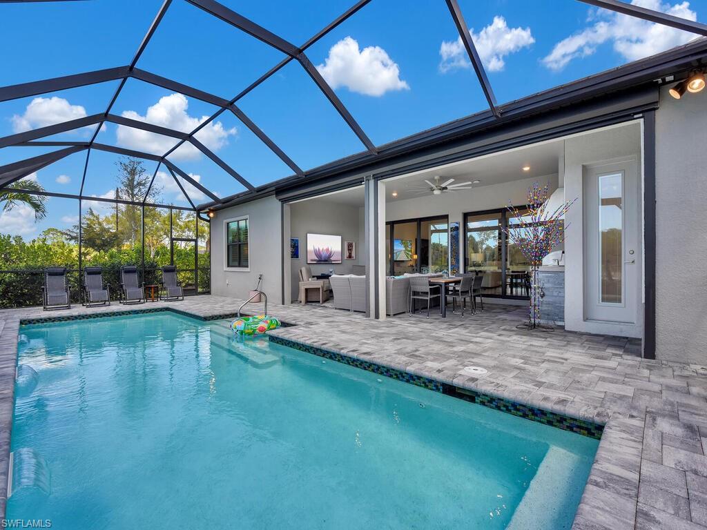7229 Wiregrass Court Naples, FL 34114 - Photo 35 of 40 a view of swimming pool with outdoor seating