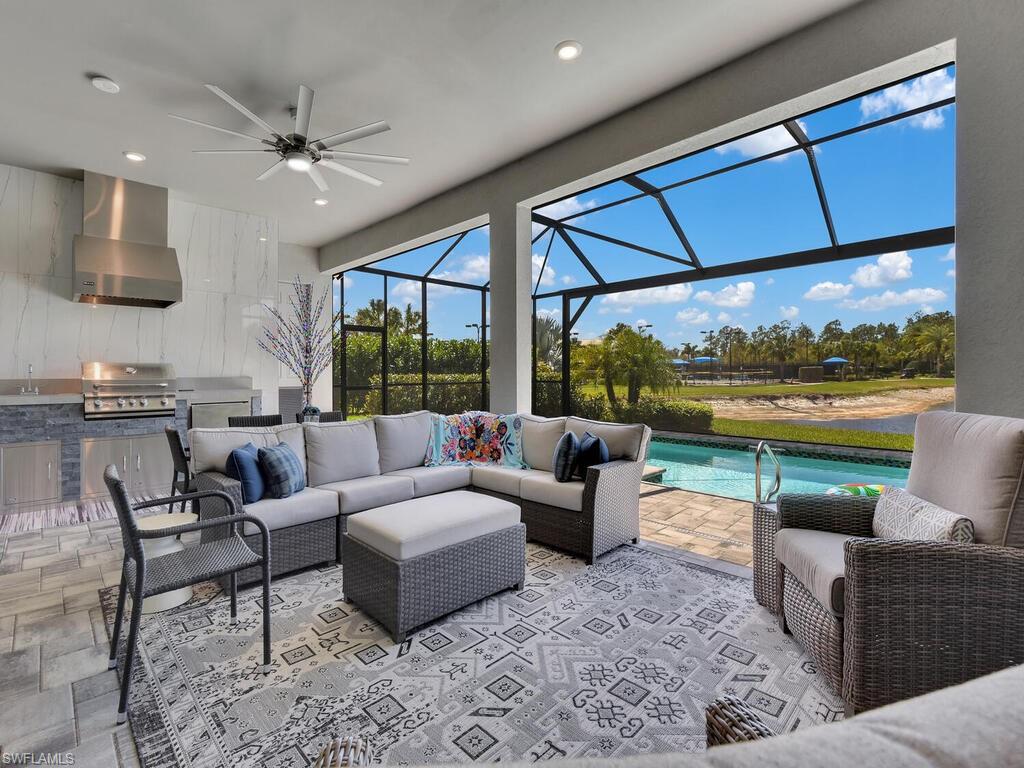 7229 Wiregrass Court Naples, FL 34114 - Photo 36 of 40 a living room with patio furniture and a floor to ceiling window