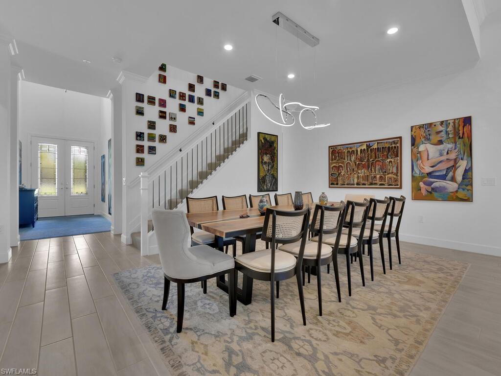 7229 Wiregrass Court Naples, FL 34114 - Photo 5 of 40 a dining room with furniture and wooden floor