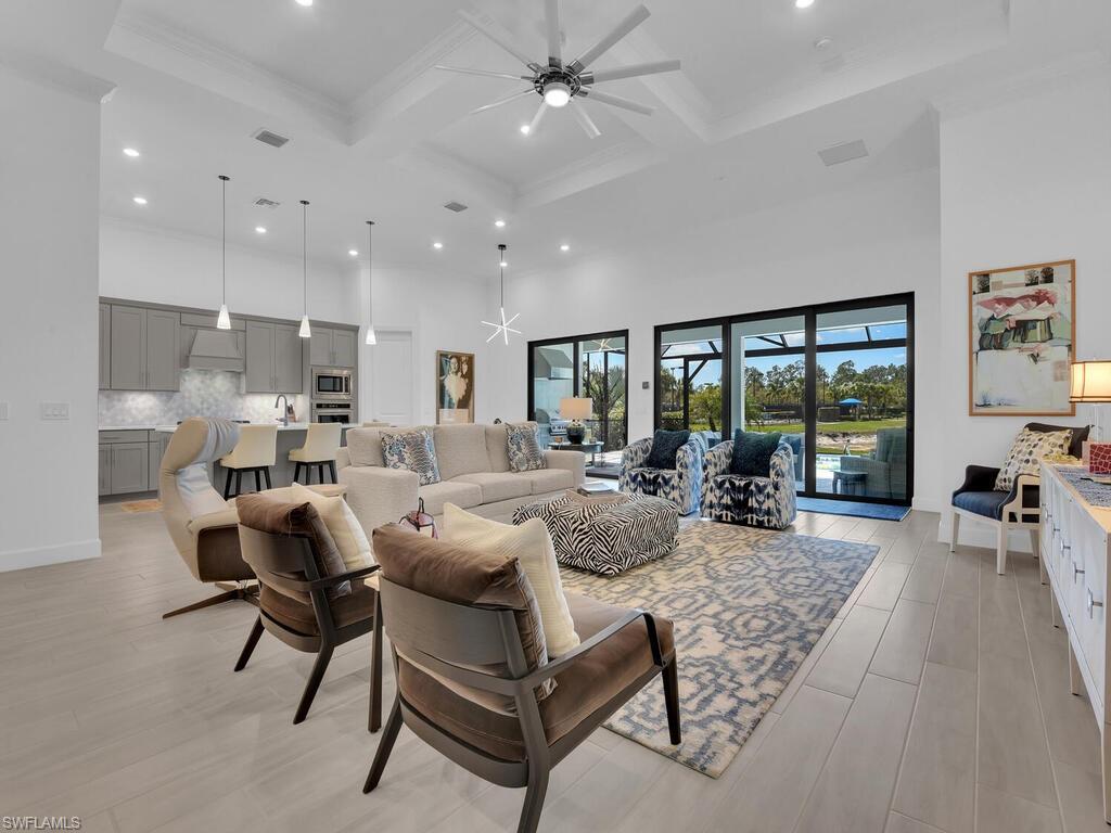 7229 Wiregrass Court Naples, FL 34114 - Photo 9 of 40 a living room with furniture and a large window