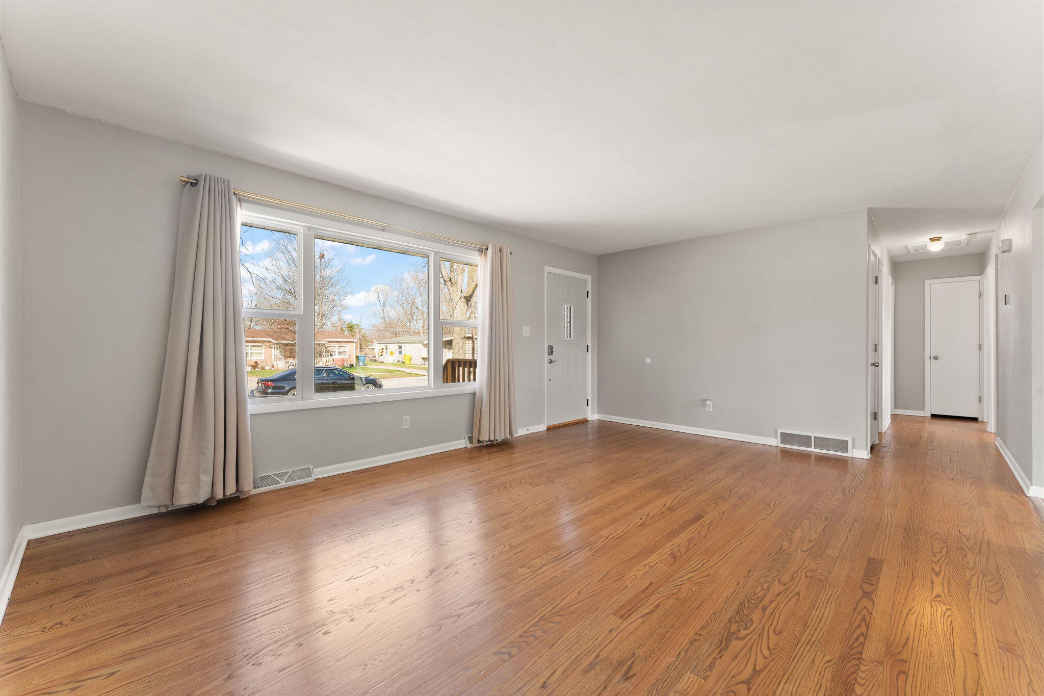 947 North Wood Street Griffith, IN 46319 - Photo 5 of 25 a view of an empty room with wooden floor and a window