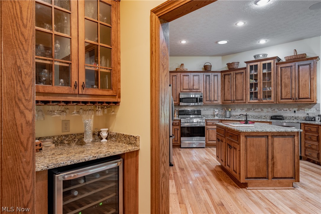 3908 River Road Vienna, WV 26105 - Photo 18 of 48 Between the kitchen and dining room is a butlers pantry featuring a wine cooler, granite counters and plenty of glassware storage