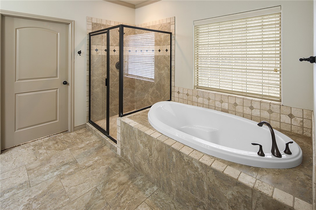 4662 Hidden Springs Way College Station, TX 77845 - Photo 24 of 48 a bathroom with a tub and shower