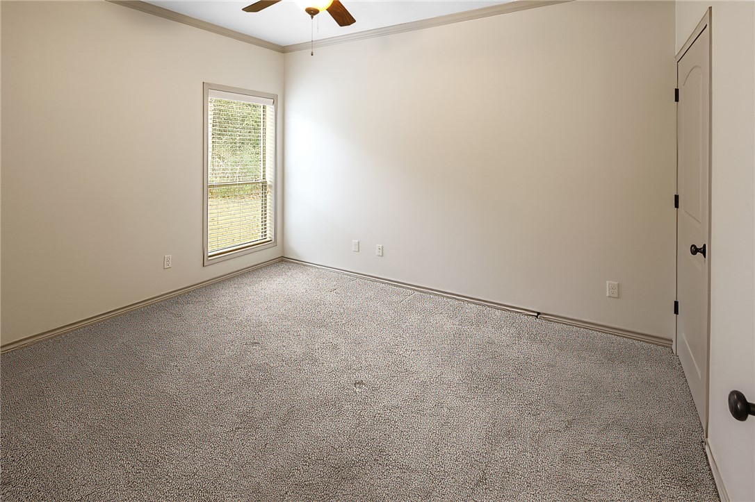 4662 Hidden Springs Way College Station, TX 77845 - Photo 26 of 48 an empty room with a window and chandelier fan