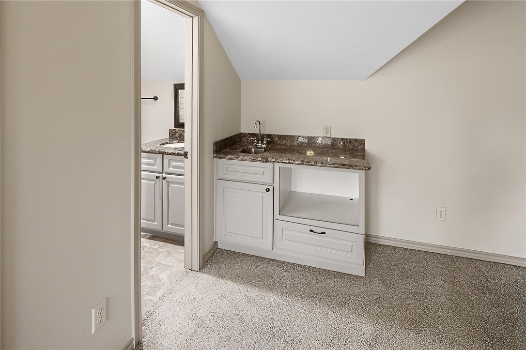 4662 Hidden Springs Way College Station, TX 77845 - Photo 35 of 48 a kitchen with white cabinets and a stove