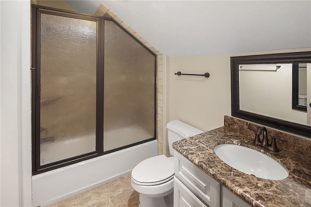 4662 Hidden Springs Way College Station, TX 77845 - Photo 36 of 48 a bathroom with a granite countertop sink toilet and shower