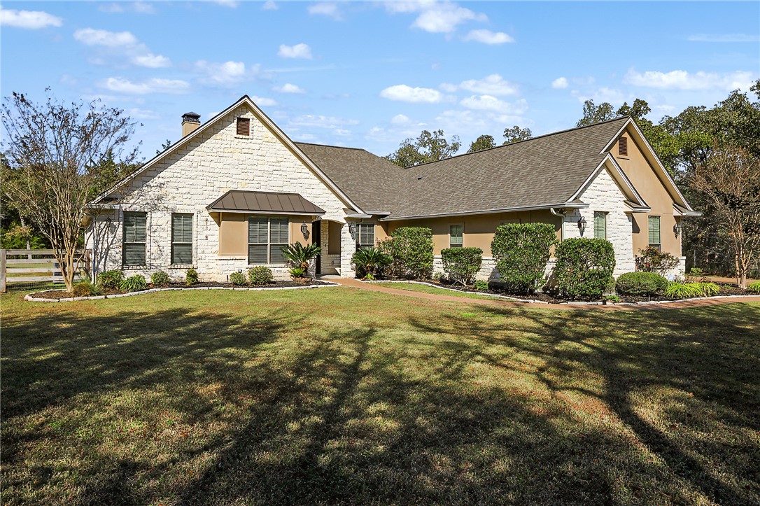 4662 Hidden Springs Way College Station, TX 77845 - Photo 4 of 48 a front view of a house with a yard