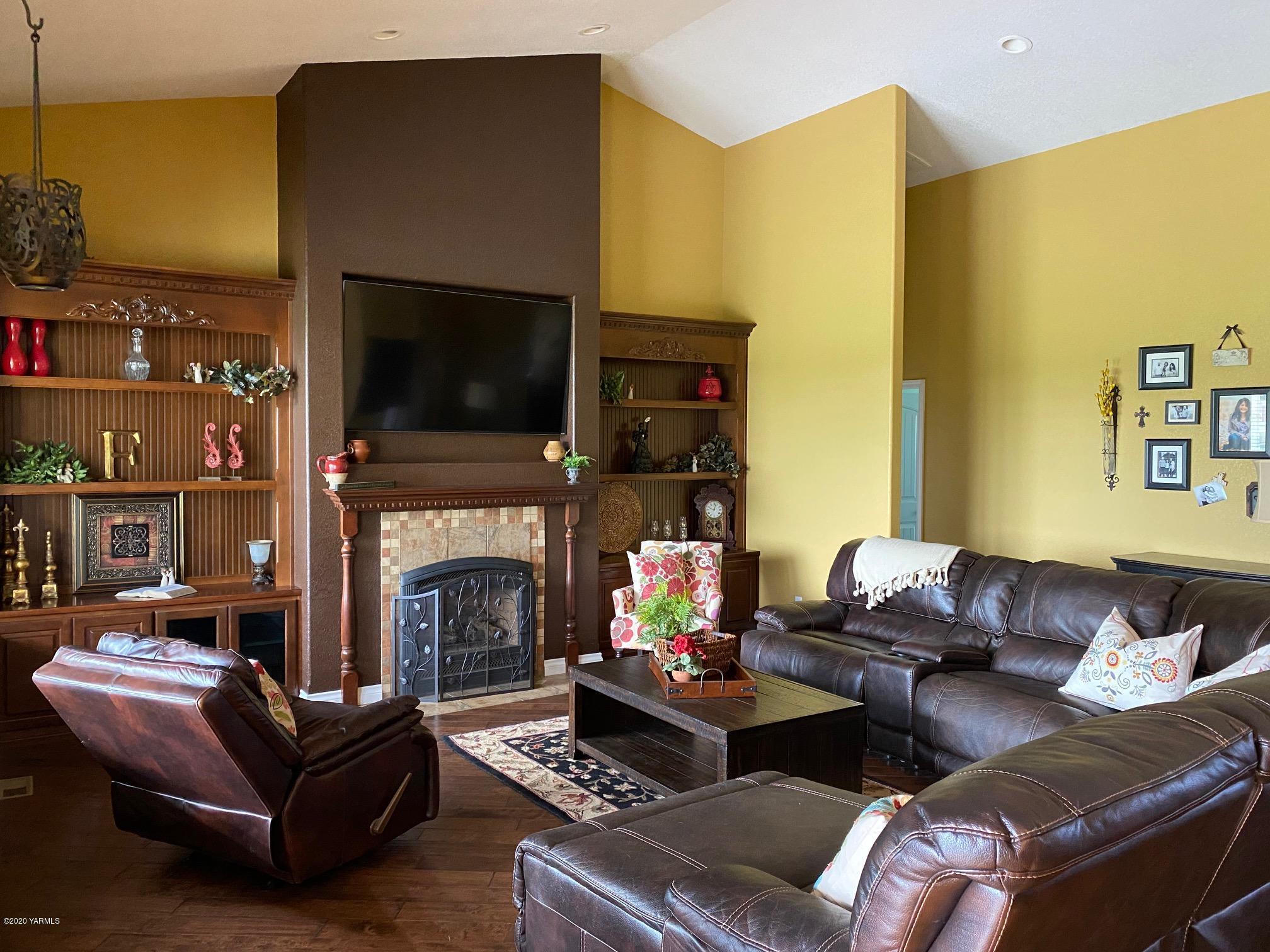 3365 Waneta Road Grandview, WA 98930 - Photo 14 of 35 a living room with furniture a fireplace and a flat screen tv