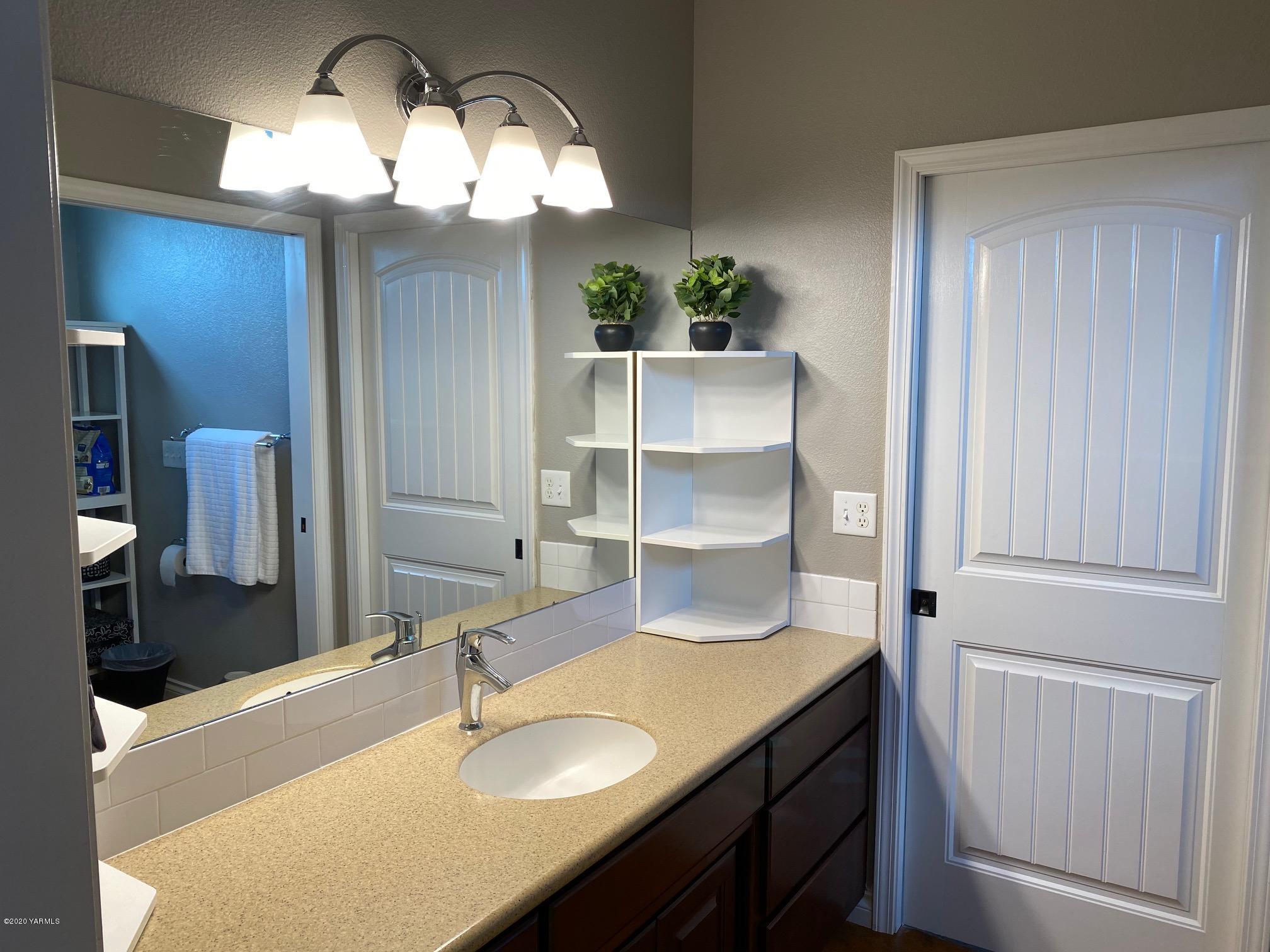 3365 Waneta Road Grandview, WA 98930 - Photo 30 of 35 a bathroom with a sink and a mirror