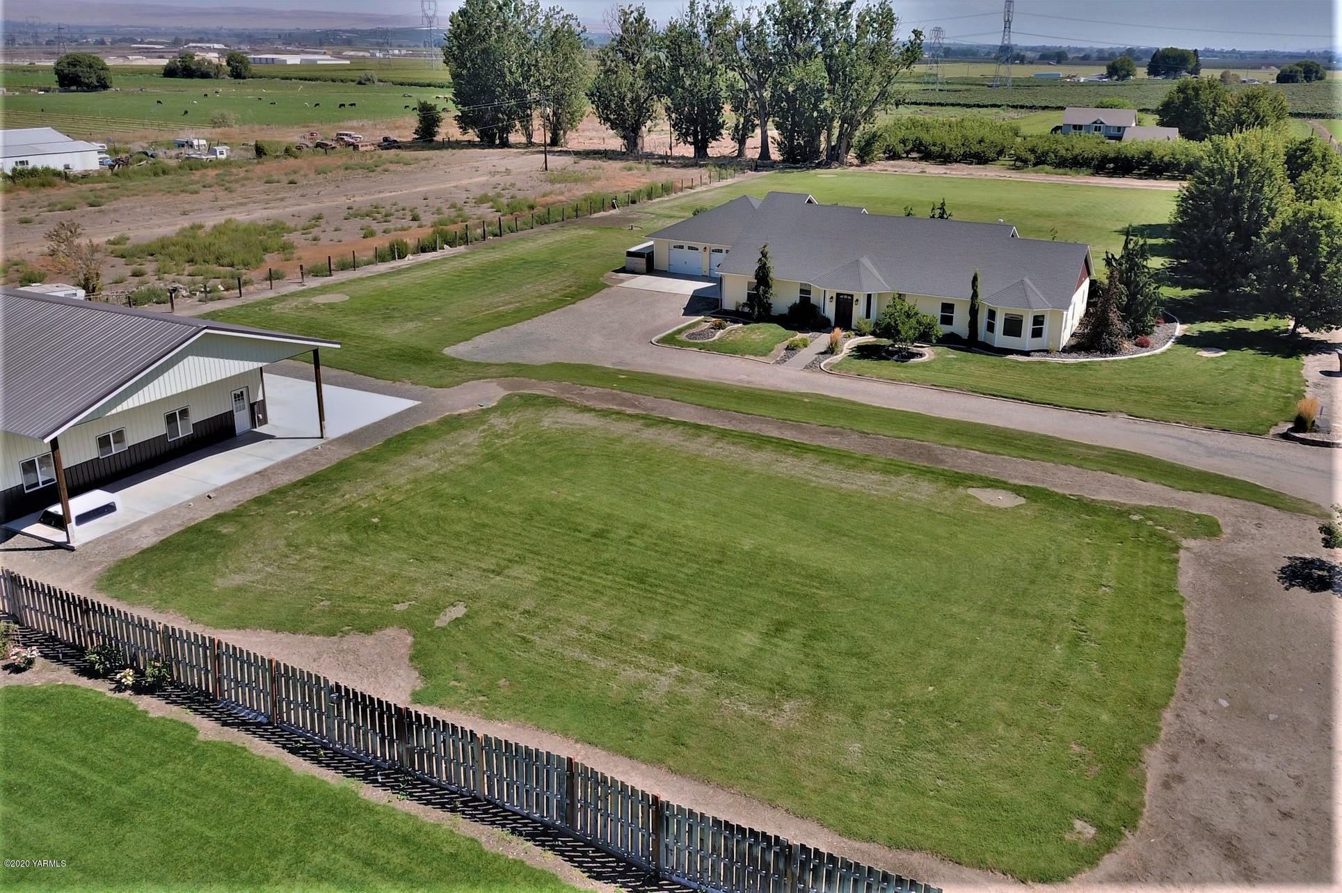3365 Waneta Road Grandview, WA 98930 - Photo 7 of 35 a view of a swimming pool with lawn chairs and a big yard