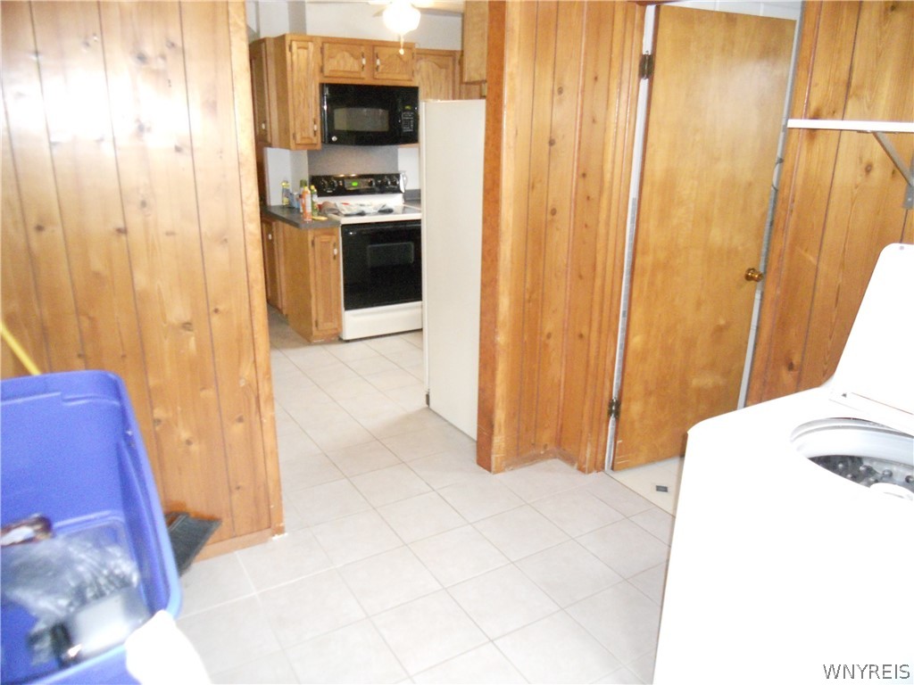7041 Maple Road Alabama, NY 14013 - Photo 23 of 50 Laundry room into kitchen, bathroom to the right