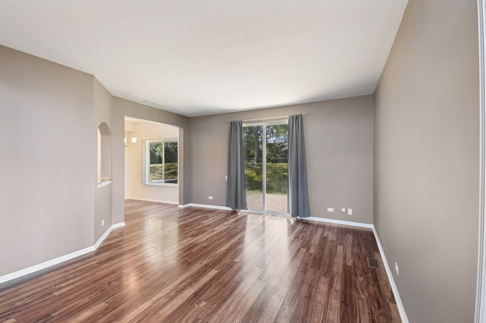 780 Mesa Drive, Unit 780 Elgin, IL 60123 - Photo 7 of 25 wooden floor in an empty room with a window
