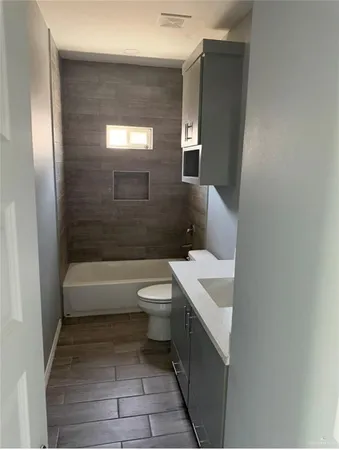 a bathroom with a sink a toilet and bathtub