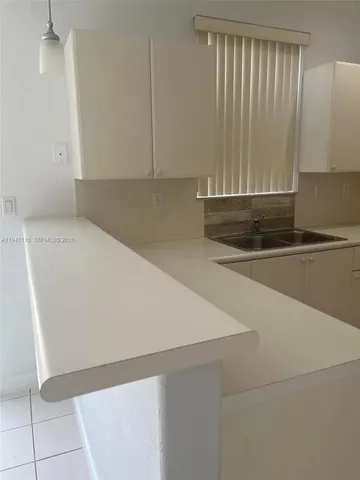 a view of a kitchen with a sink