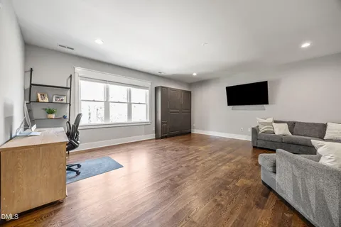 a bedroom with a bed and glass door
