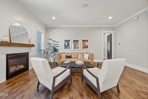a living room with furniture fireplace and window