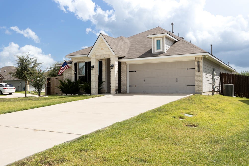 1001 Rootstock Rd. Brenham, TX 77833 - Photo 2 of 28 a front view of a house with a yard and garage