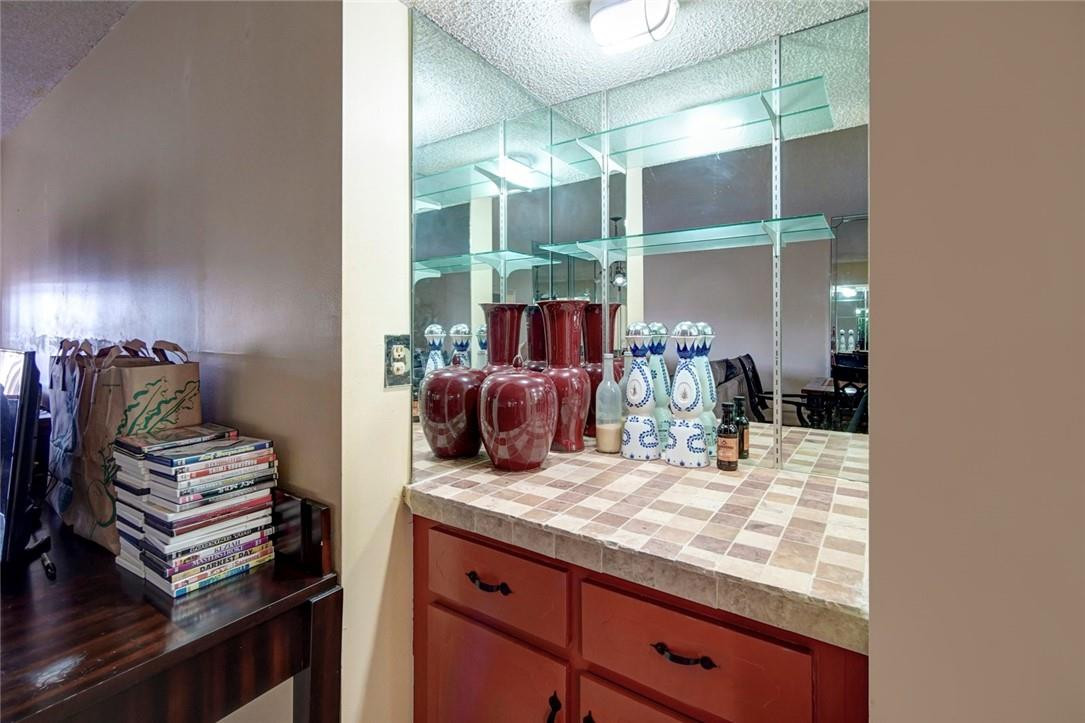 9370 Southwest 8th Street, Unit 408 Boca Raton, FL 33428 - Photo 8 of 24 The living room has a wet bar.