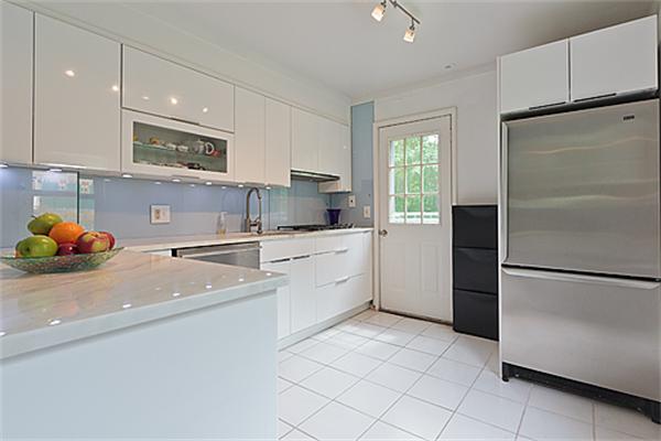 66 Munroe Road Lexington, MA 02421 - Photo 4 of 15 a kitchen with a sink a refrigerator and cabinets