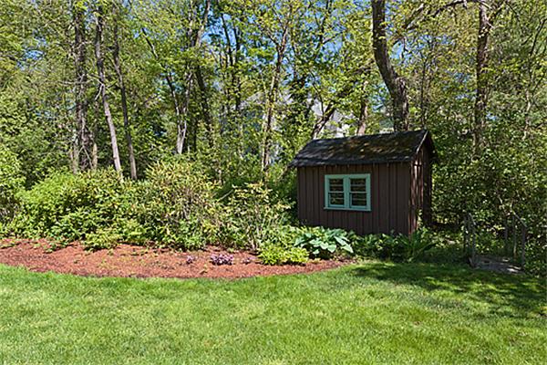 66 Munroe Road Lexington, MA 02421 - Photo 9 of 15 a view of a garden with plants and large trees