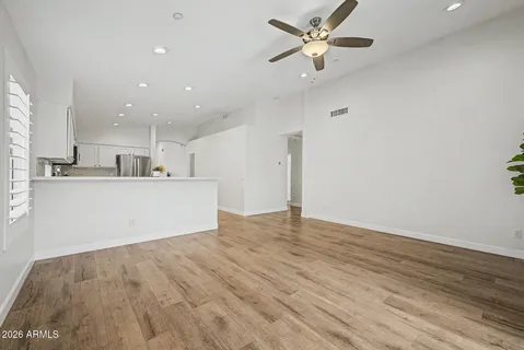 a kitchen with a sink cabinets and wooden floor